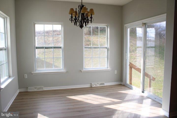 304 Cape Climb York, PA 17408 - Photo 4 of 6 an empty room with wooden floor and windows