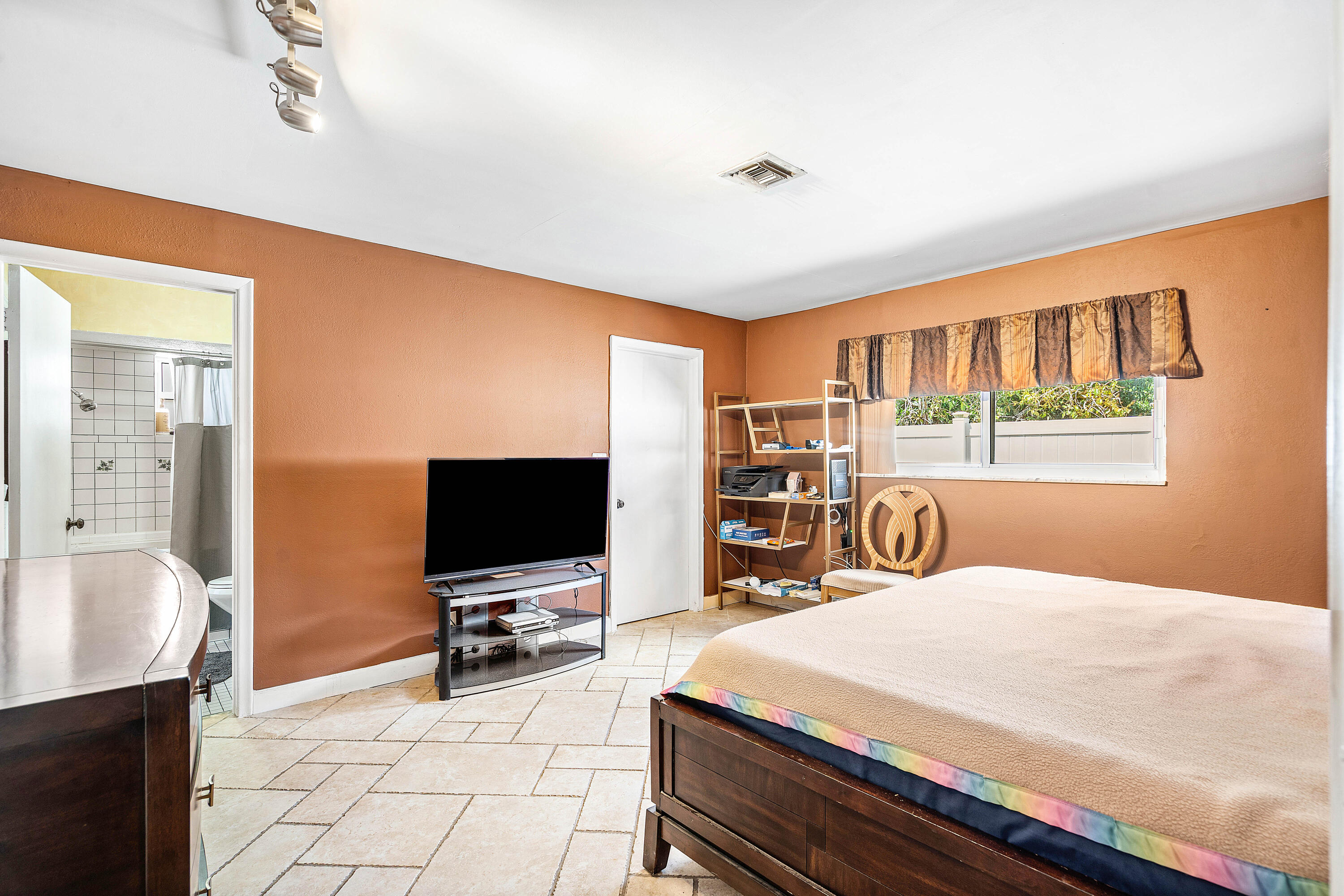 5811 Southwest 53rd Terrace Davie, FL 33314 - Photo 13 of 31 a bedroom with a bed and a flat screen tv