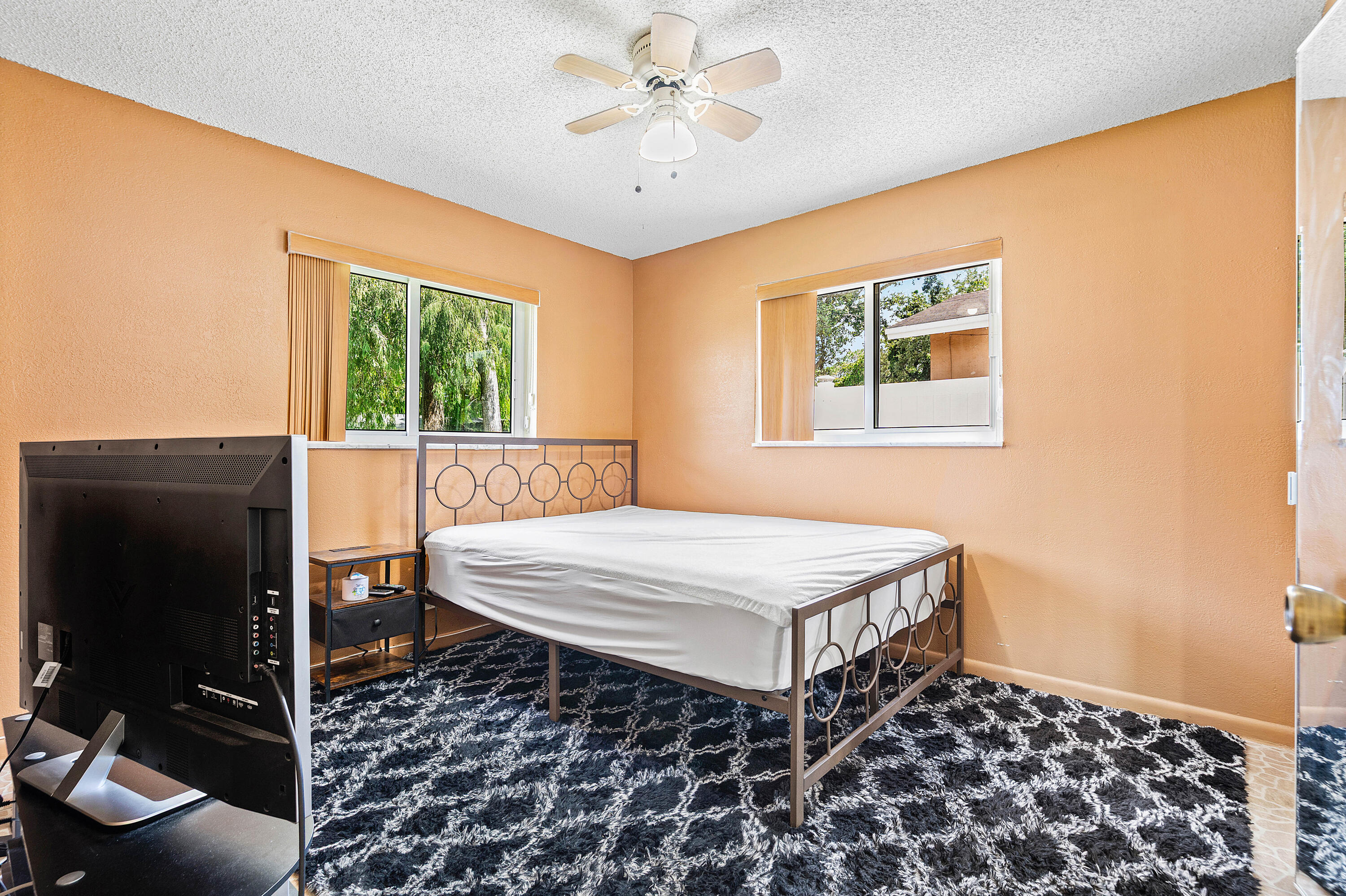 5811 Southwest 53rd Terrace Davie, FL 33314 - Photo 15 of 31 a bedroom with a bed and a flat screen tv
