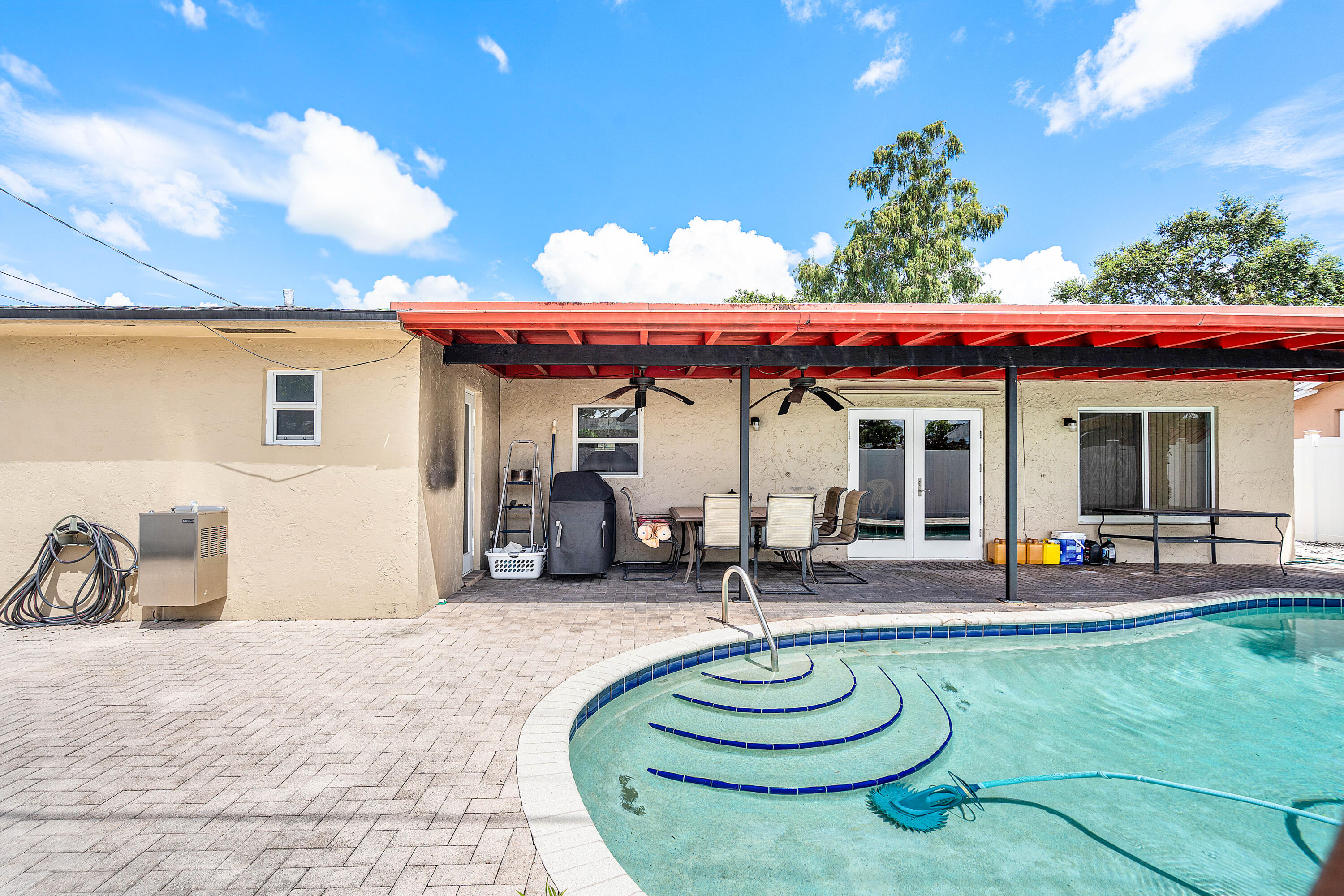 5811 Southwest 53rd Terrace Davie, FL 33314 - Photo 18 of 31 a patio with a table and chairs and potted plants