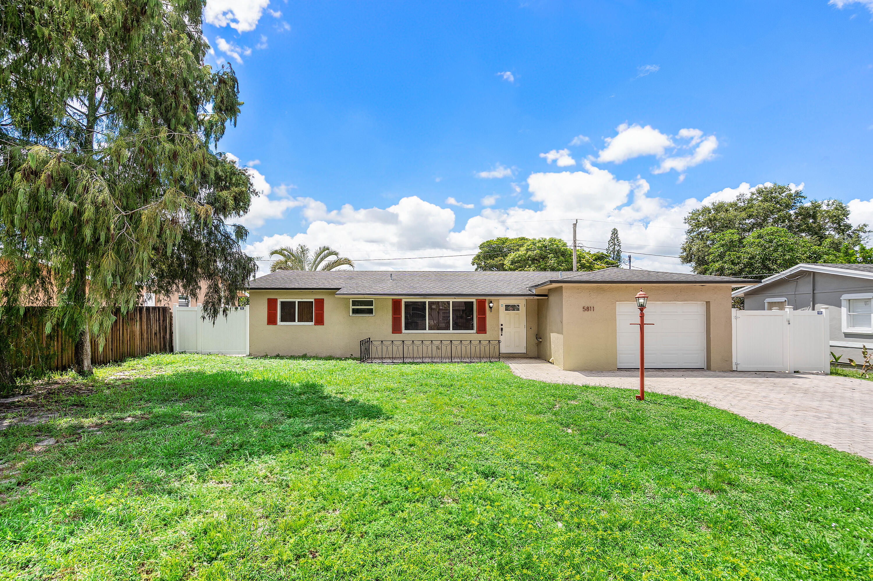 5811 Southwest 53rd Terrace Davie, FL 33314 - Photo 2 of 31 a view of a house with a yard and potted plants