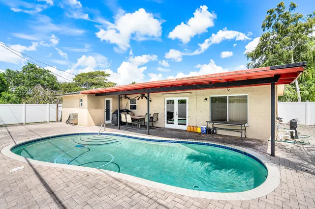 a view of a house with backyard sitting area and porch