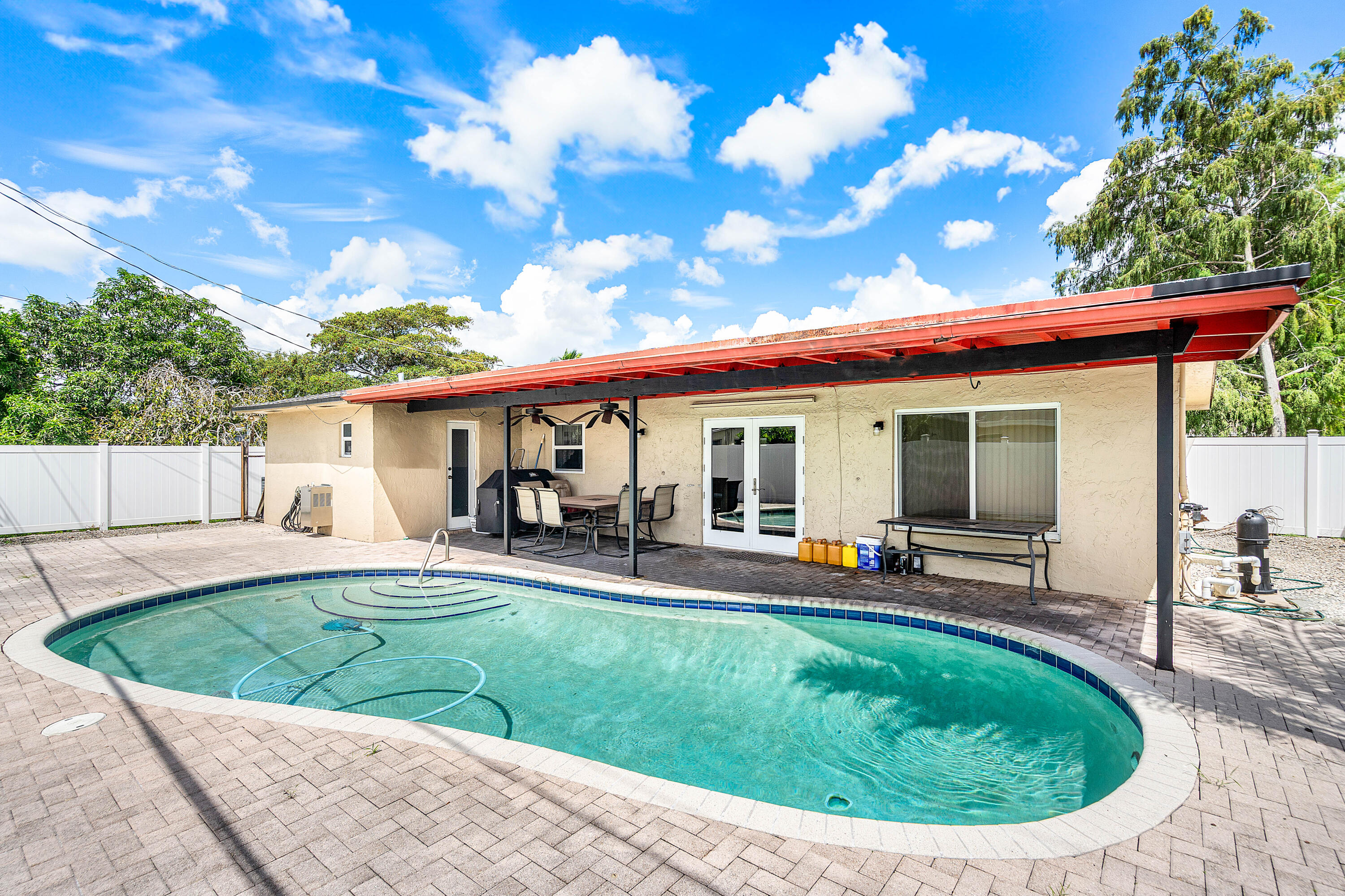 5811 Southwest 53rd Terrace Davie, FL 33314 - Photo 23 of 31 a view of a house with backyard sitting area and porch