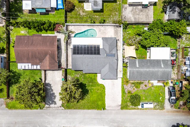 an aerial view of a house with a yard