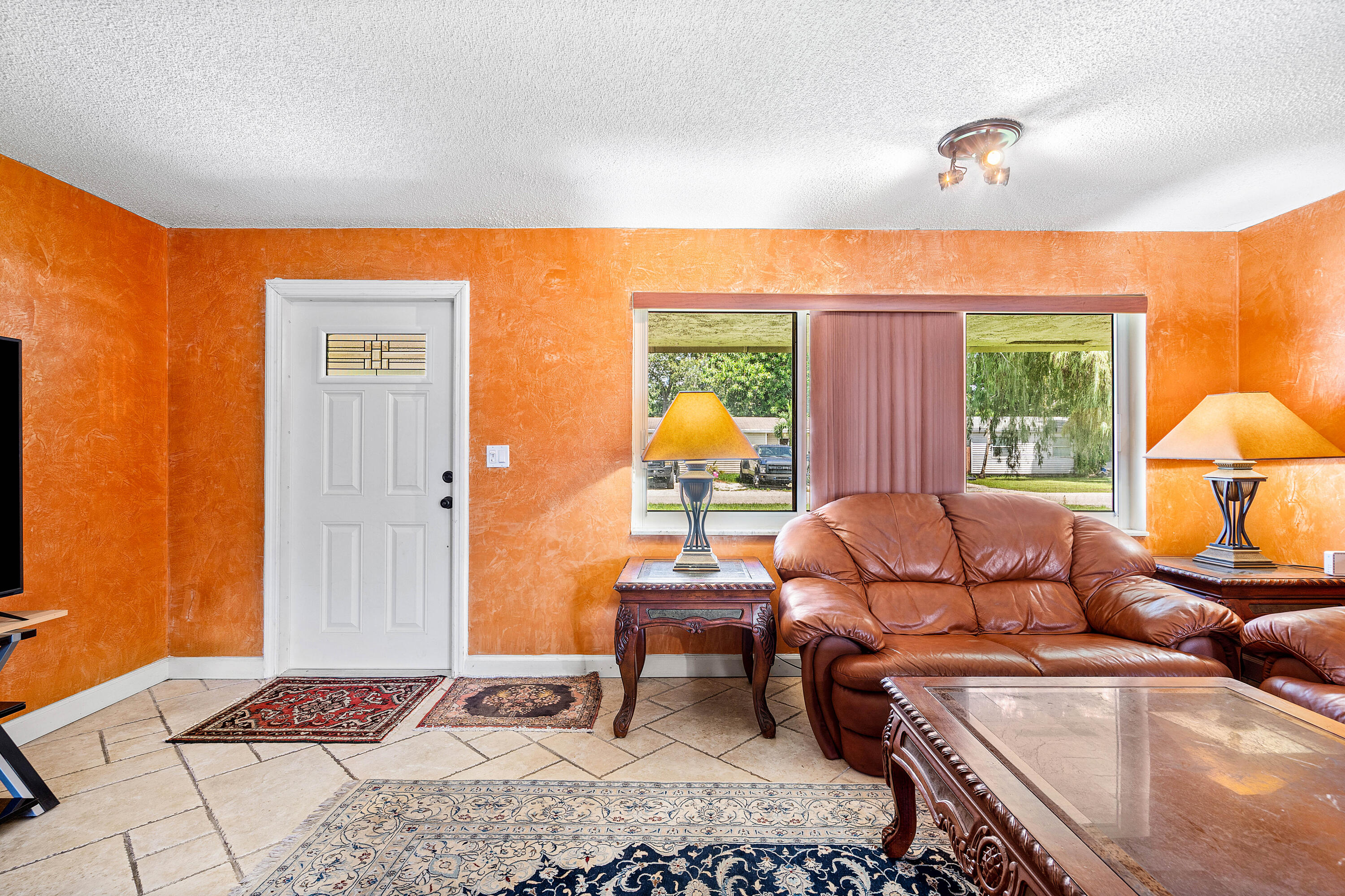 5811 Southwest 53rd Terrace Davie, FL 33314 - Photo 3 of 31 a living room with furniture a lamp next to a window