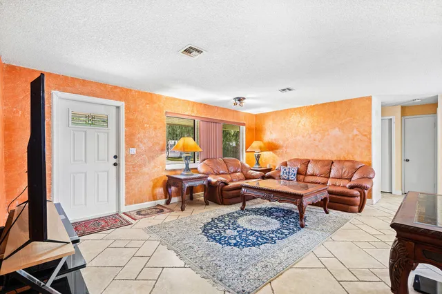 a living room with furniture a rug and a large window