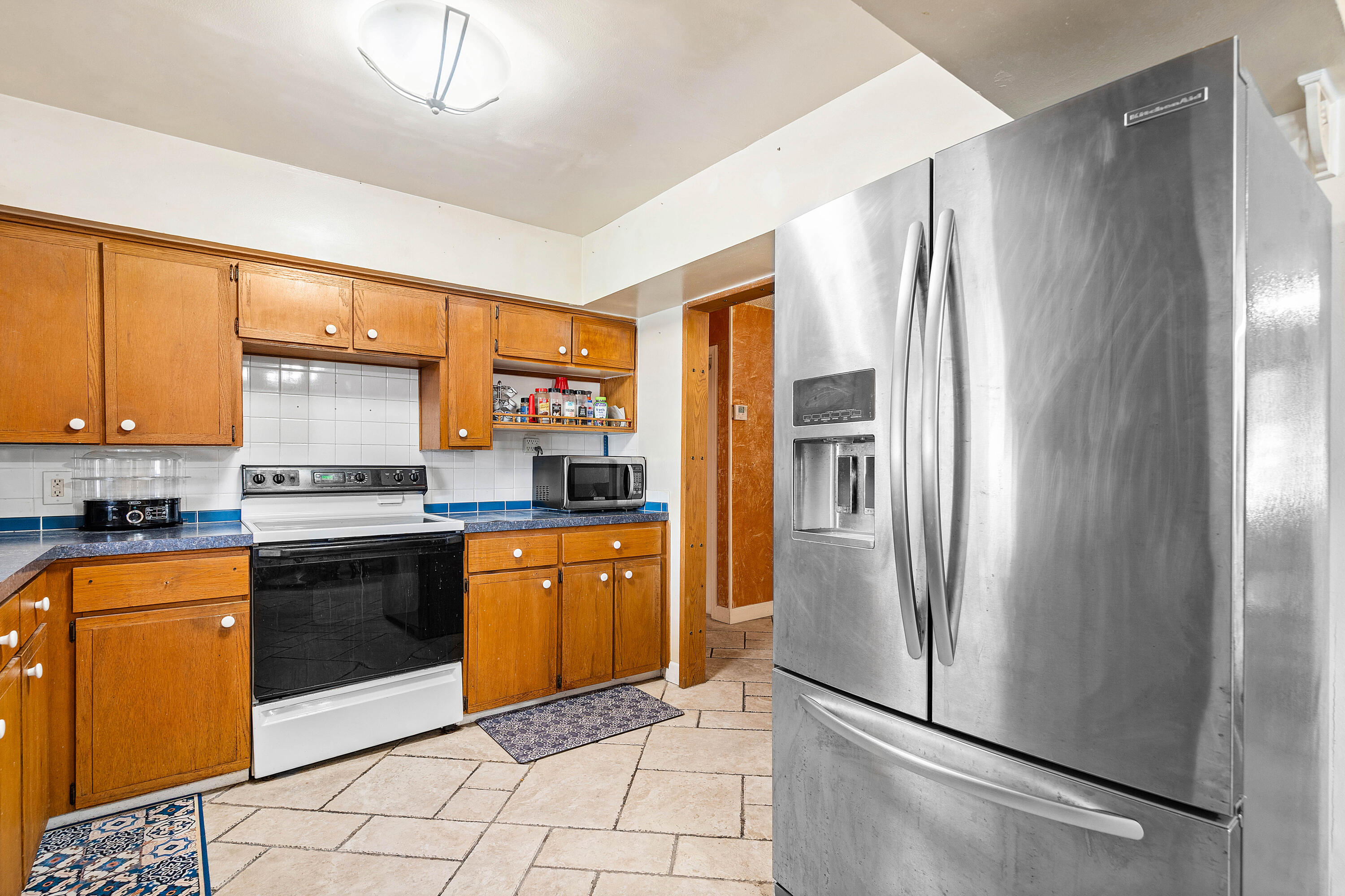 5811 Southwest 53rd Terrace Davie, FL 33314 - Photo 10 of 31 a kitchen with stainless steel appliances granite countertop a refrigerator a sink a stove and white cabinets