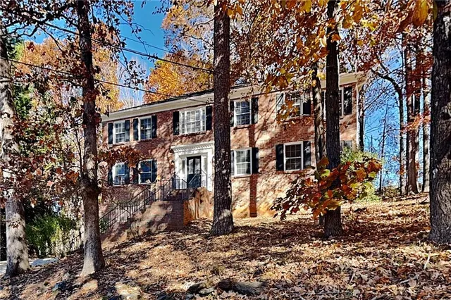 a view of a blue house with a yard