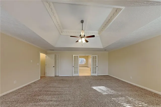 a view of an empty room and window ceiling fan