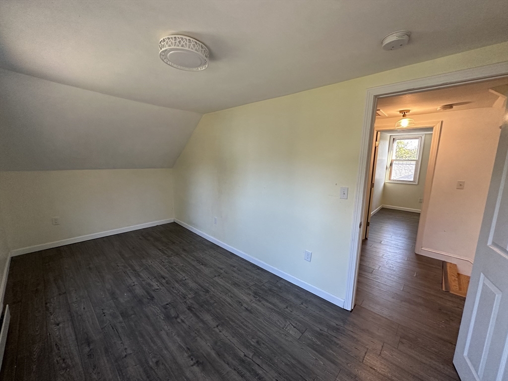 8 Pike Street Hopkinton, MA 01748 - Photo 30 of 34 a view of an empty room with wooden floor and a window