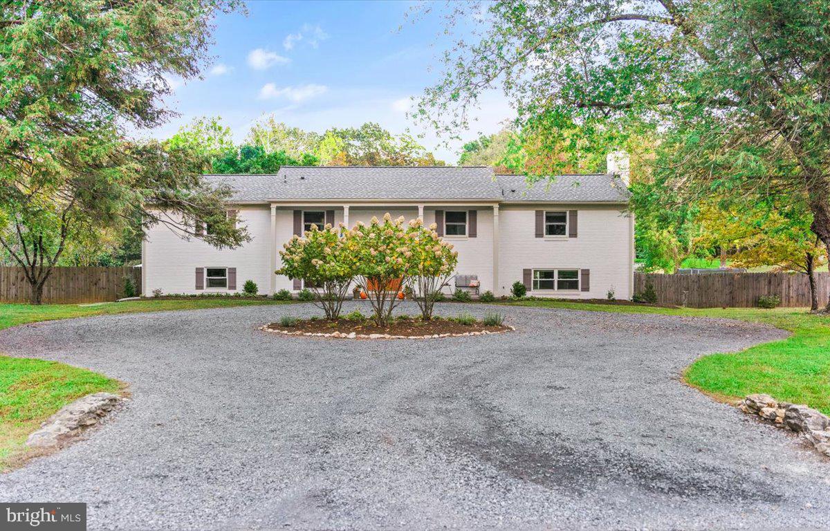 Front exterior with circular driveway.