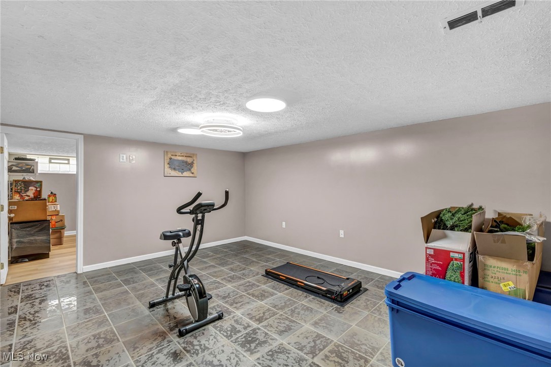 13508 Whitney Road Strongsville, OH 44136 - Photo 30 of 32 Workout area featuring a textured ceiling