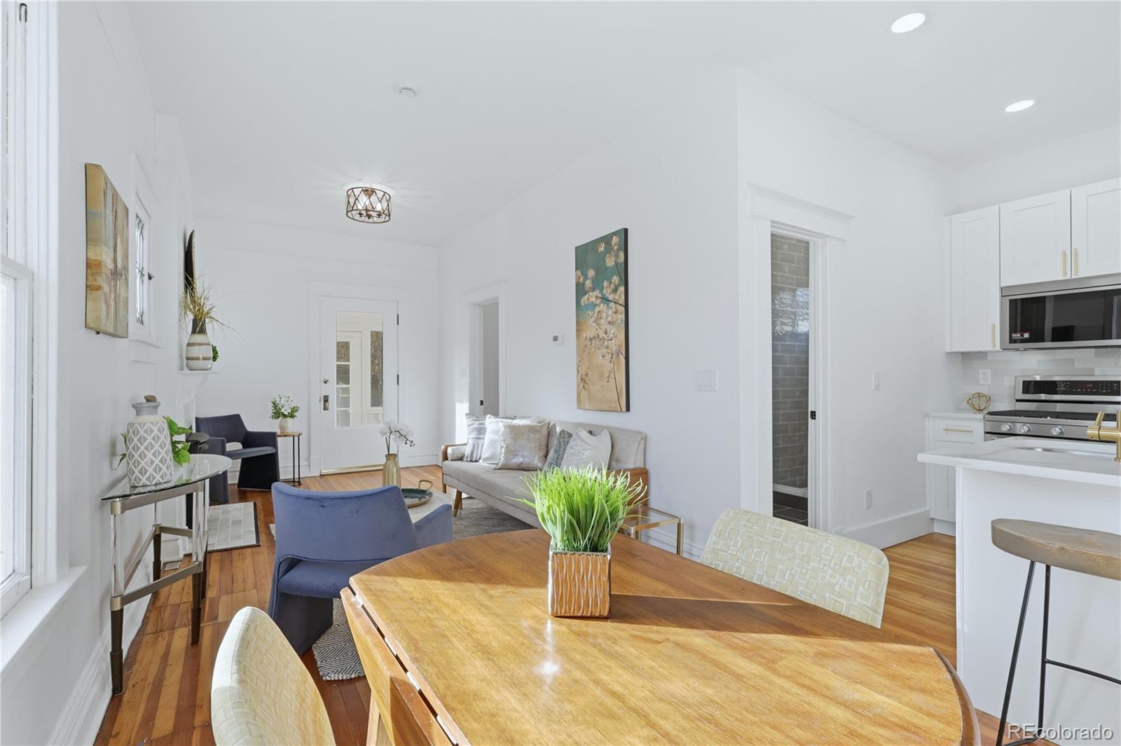 3051 West 37th Avenue Denver, CO 80211 - Photo 11 of 37 a living room with furniture dining table and wooden floor