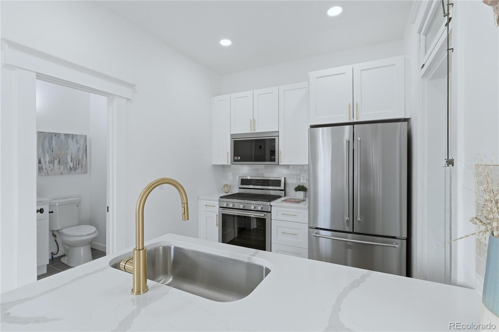 3051 West 37th Avenue Denver, CO 80211 - Photo 14 of 37 a kitchen with a refrigerator sink and stainless steel appliances