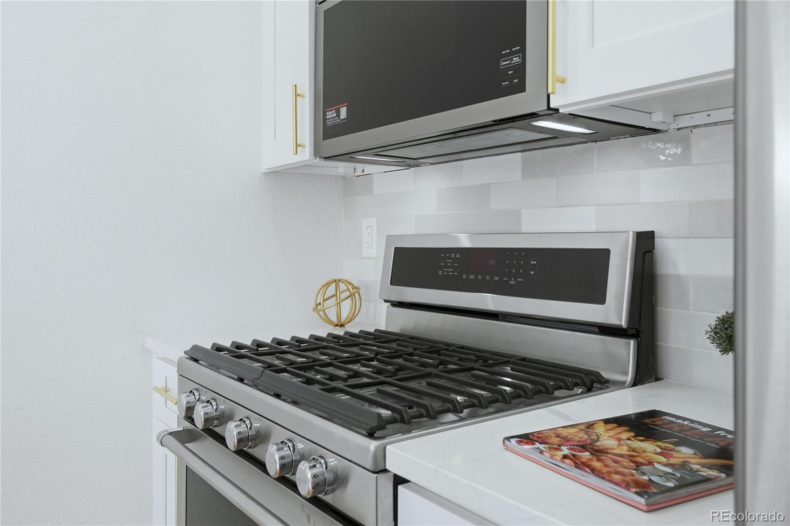 3051 West 37th Avenue Denver, CO 80211 - Photo 17 of 37 a stove top oven sitting inside of a kitchen