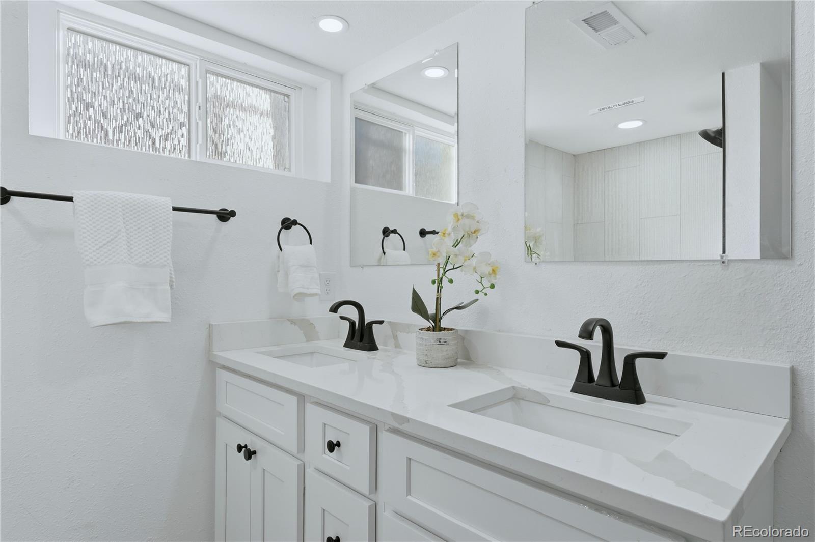 3051 West 37th Avenue Denver, CO 80211 - Photo 27 of 37 a bathroom with a sink and a mirror