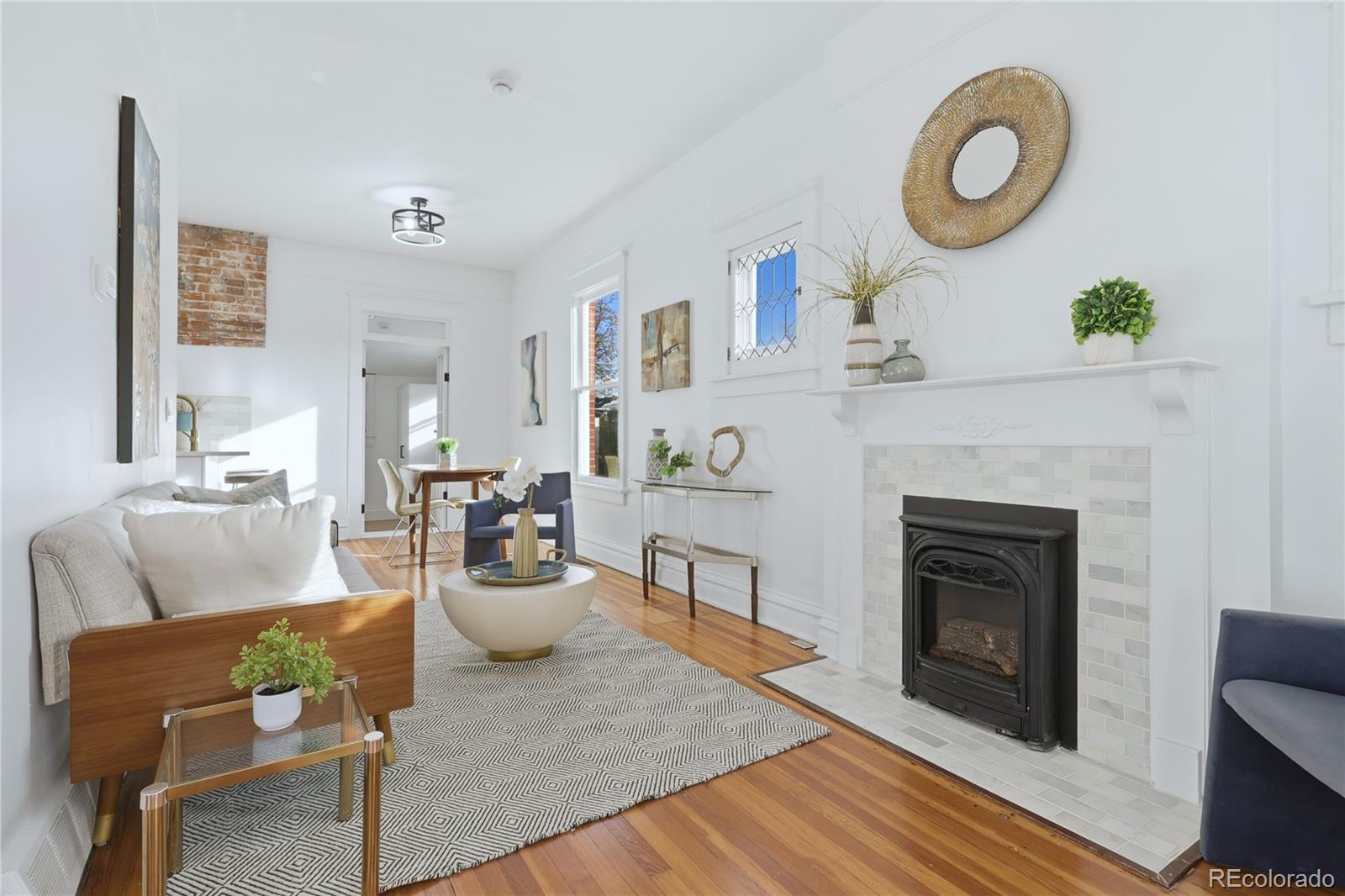3051 West 37th Avenue Denver, CO 80211 - Photo 7 of 37 a living room with furniture a fireplace and a potted plant