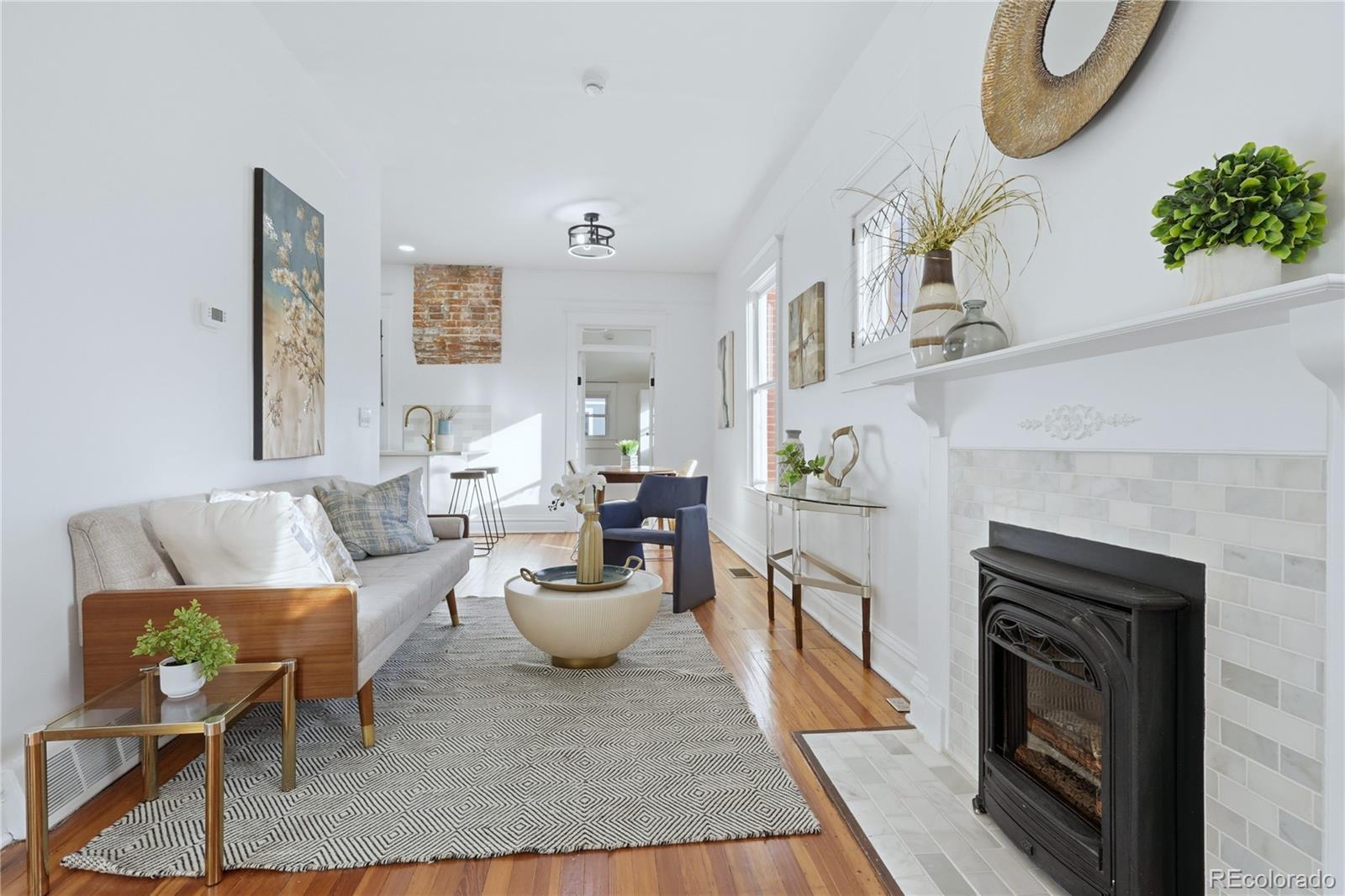 3051 West 37th Avenue Denver, CO 80211 - Photo 8 of 37 a living room with furniture a fireplace and a potted plant