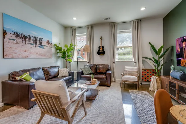 a living room with furniture and a potted plant