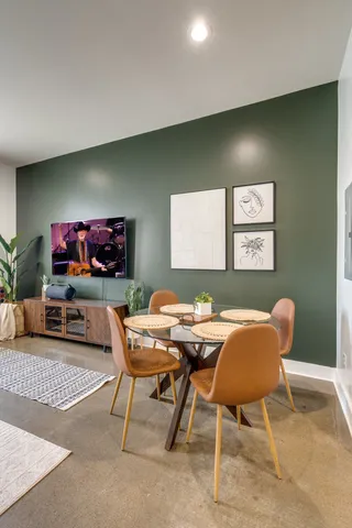 a view of a livingroom with furniture and a flat screen tv