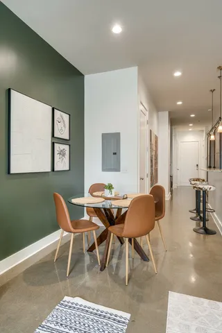 a view of a dining room with furniture and a large window