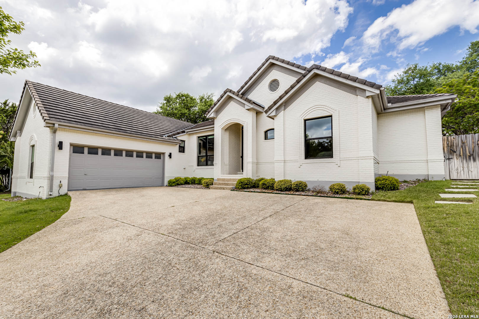 a front view of a house with a yard and garage