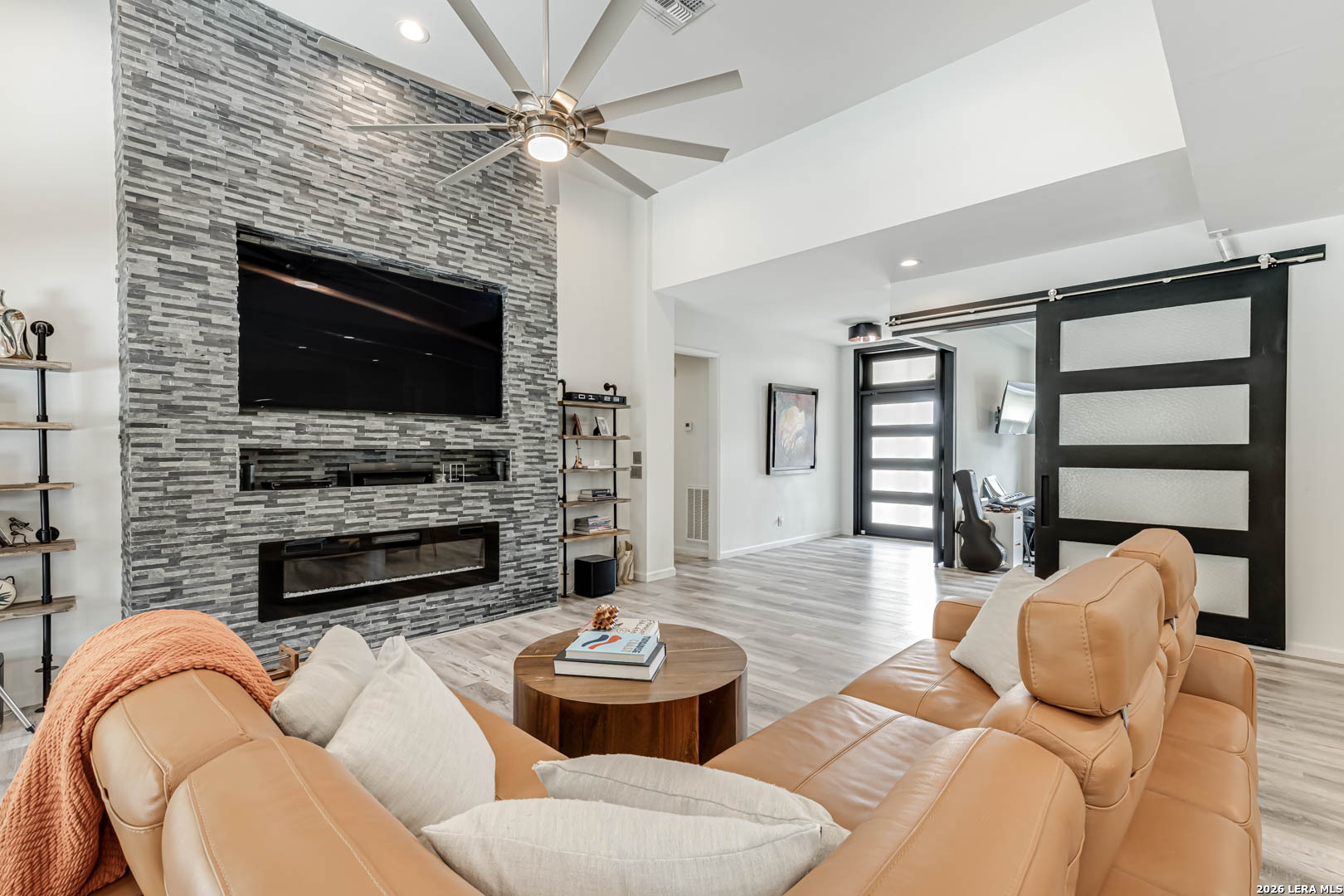 15919 Mission Ridge San Antonio, TX 78232 - Photo 14 of 43 a living room with furniture a fireplace and a flat screen tv