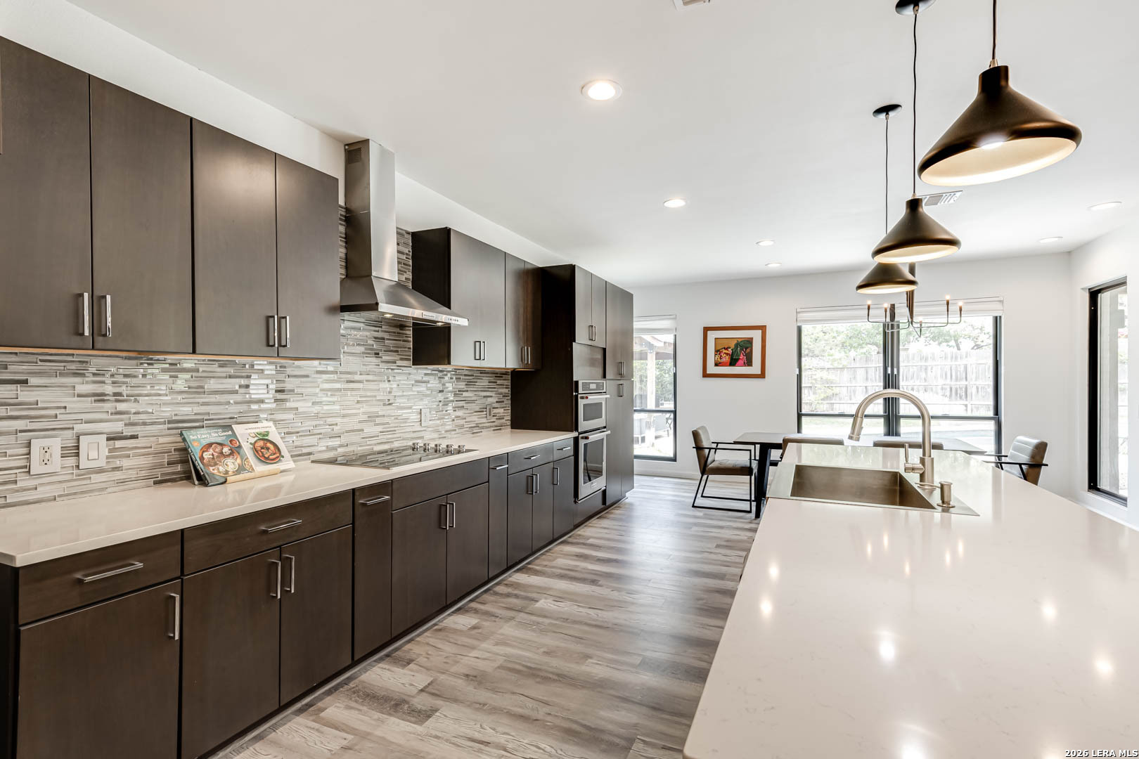 15919 Mission Ridge San Antonio, TX 78232 - Photo 24 of 43 a large kitchen with stainless steel appliances a large counter top a sink a stove and a refrigerator