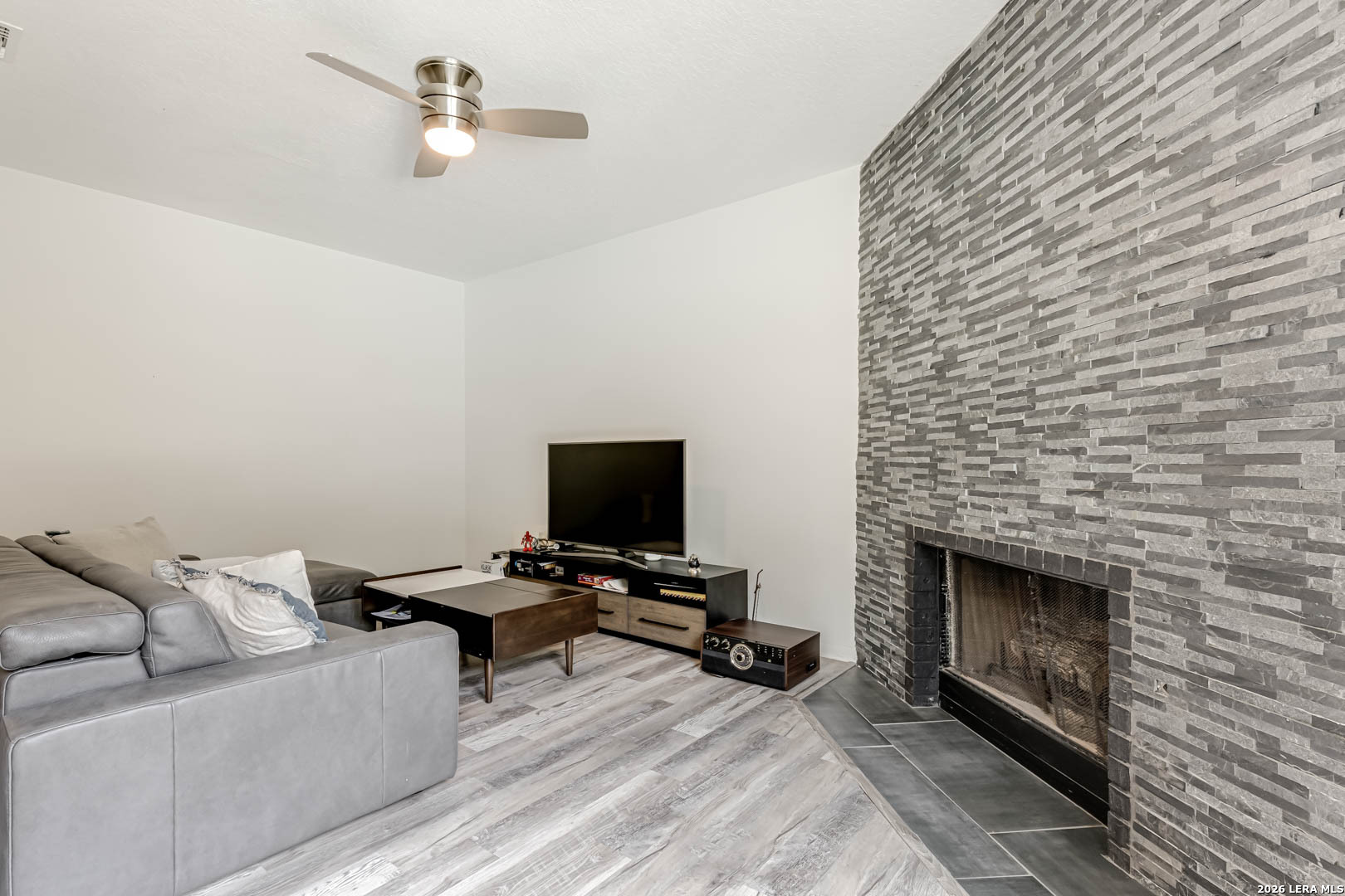 15919 Mission Ridge San Antonio, TX 78232 - Photo 27 of 43 a living room with furniture and a fireplace