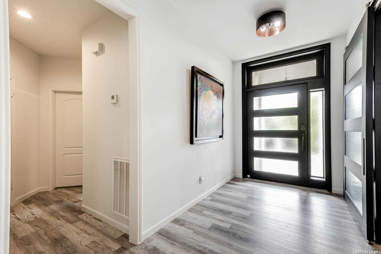15919 Mission Ridge San Antonio, TX 78232 - Photo 3 of 43 a view of a hallway with wooden floor and windows
