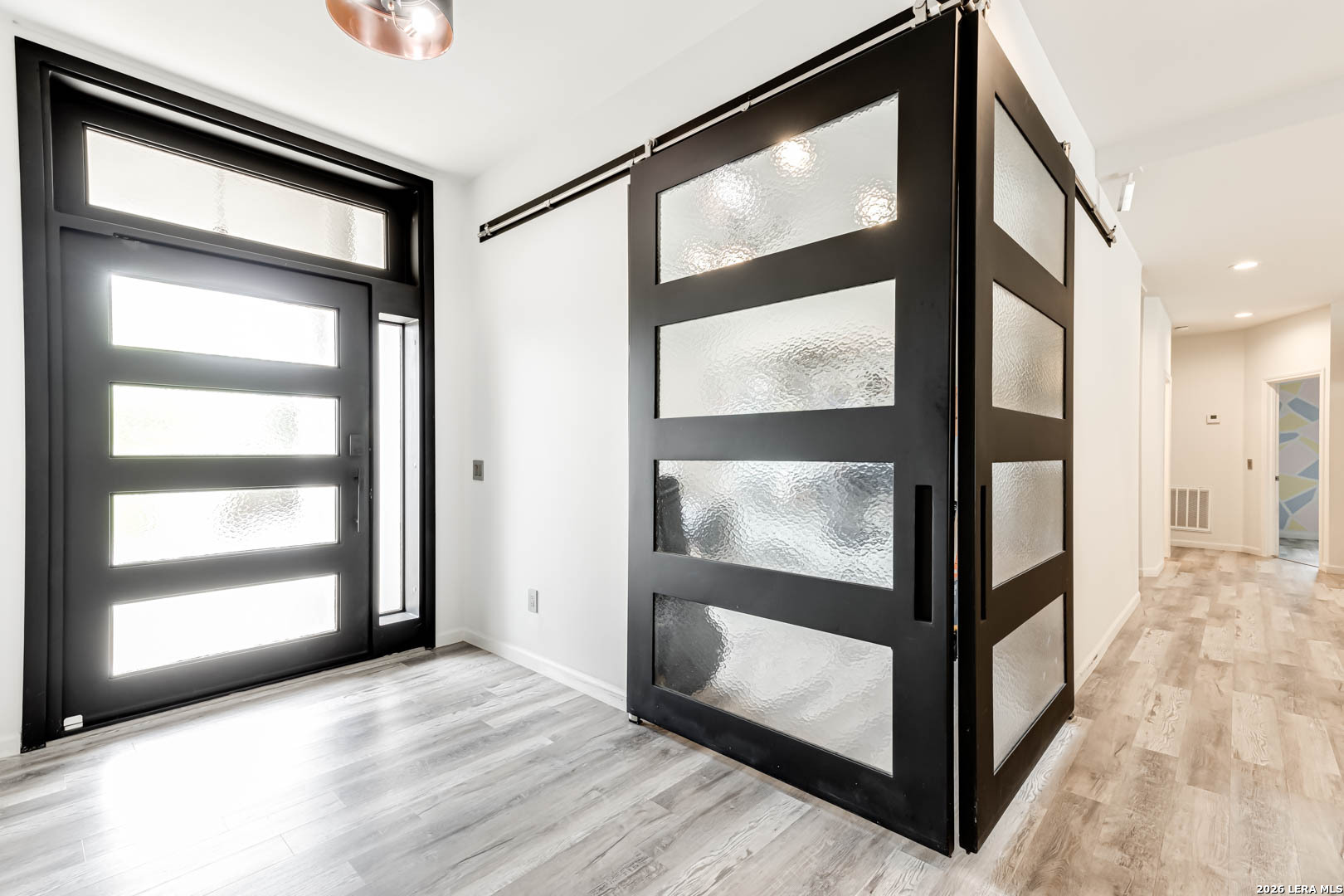 15919 Mission Ridge San Antonio, TX 78232 - Photo 4 of 43 a view of an empty room with wooden floor and a window