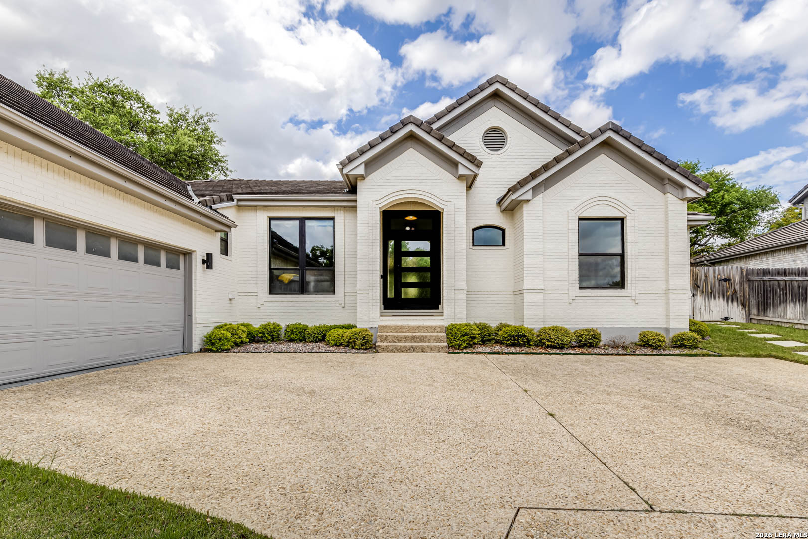 15919 Mission Ridge San Antonio, TX 78232 - Photo 5 of 43 a front view of a house with a yard and garage