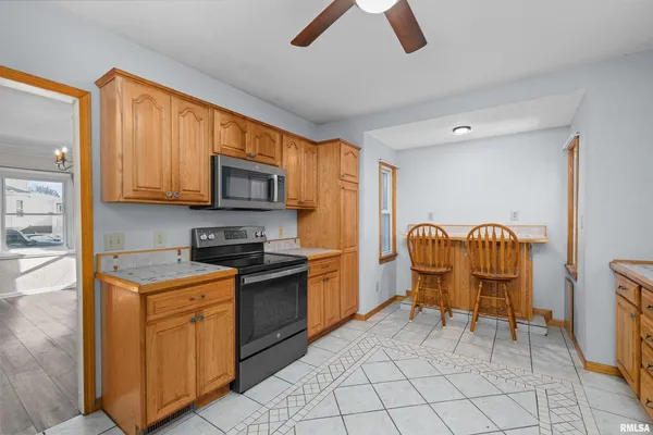 a kitchen with granite countertop cabinets stainless steel appliances and dining table