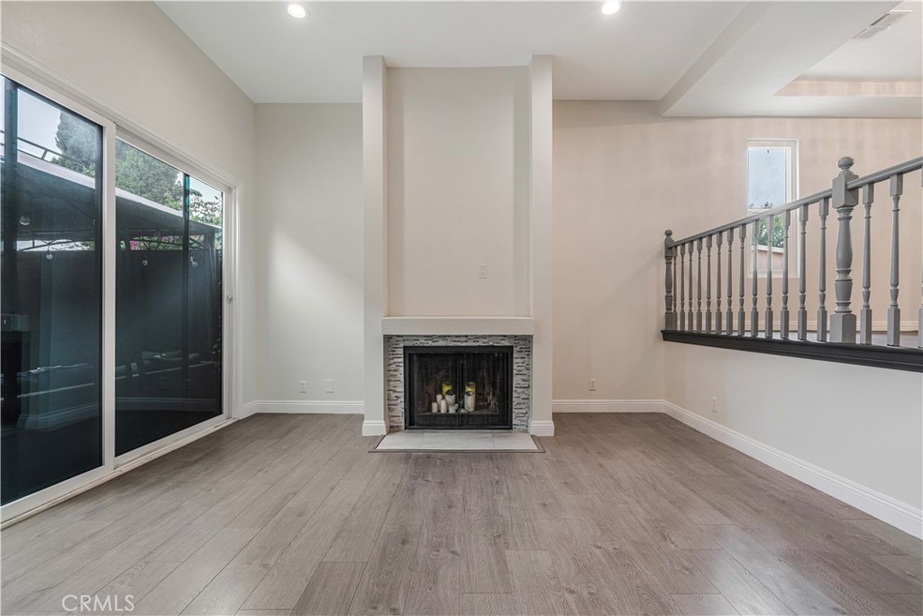 415 East Mission Road, Unit 12 Alhambra, CA 91801 - Photo 8 of 28 High Ceiling Living Room and Dining Area with a Gas Fireplace