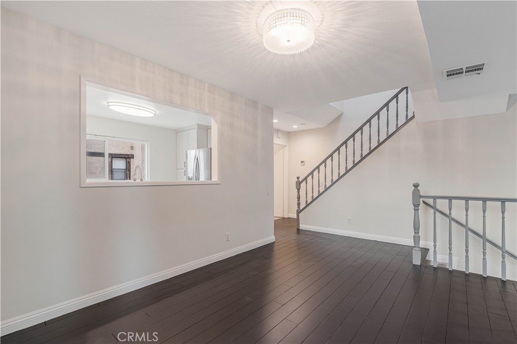 415 East Mission Road, Unit 12 Alhambra, CA 91801 - Photo 10 of 28 High Ceiling Living Room and Dining Area with a Gas Fireplace