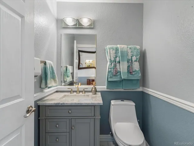 a bathroom with a toilet a sink and mirror