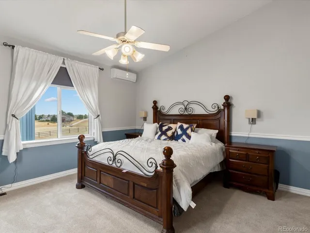 a bed sitting in a bedroom next to a window