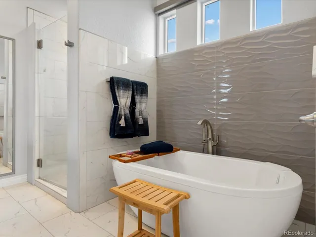 a white bath tub sitting next to a bathroom