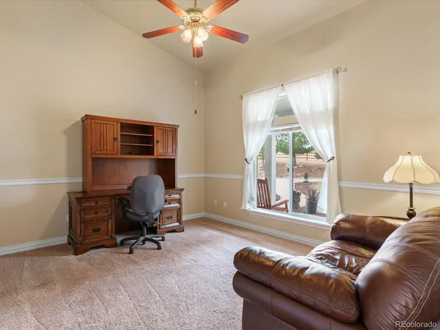 a livingroom with workspace and a couch