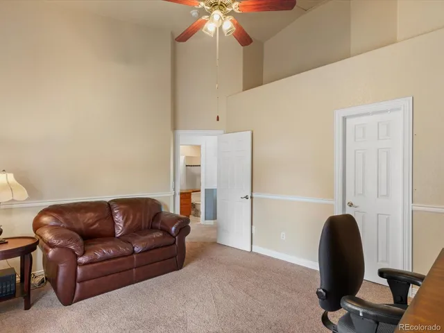 a living room with furniture and a chair
