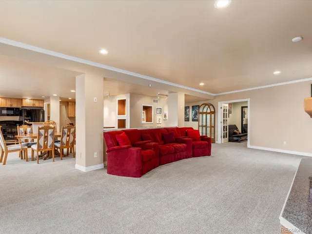 a living room with furniture and cars