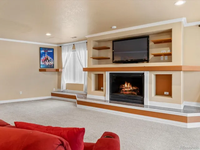 a living room with furniture flat screen tv and a fireplace