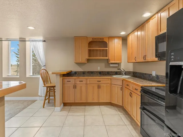 a kitchen with a sink cabinets and wooden floor