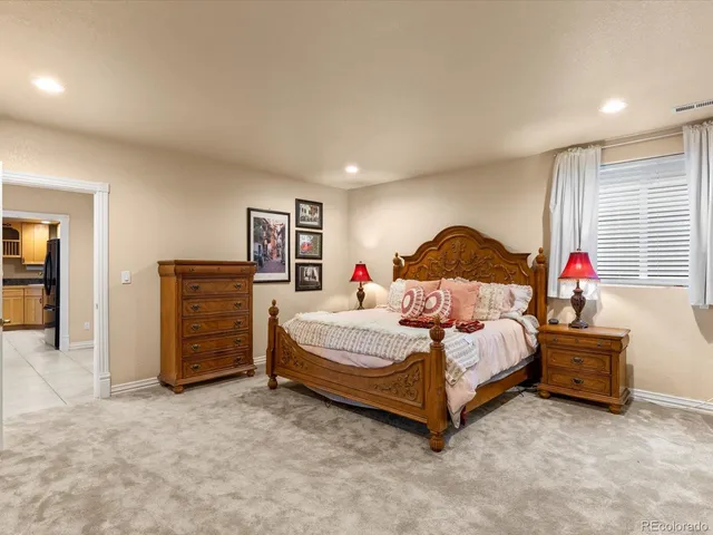 a bedroom with a bed and a painting on the wall