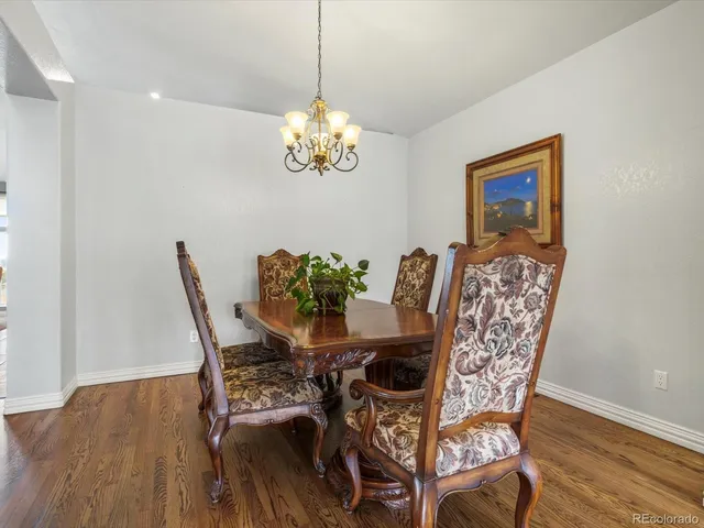 a view of a dining room with furniture wooden floor and chandelier