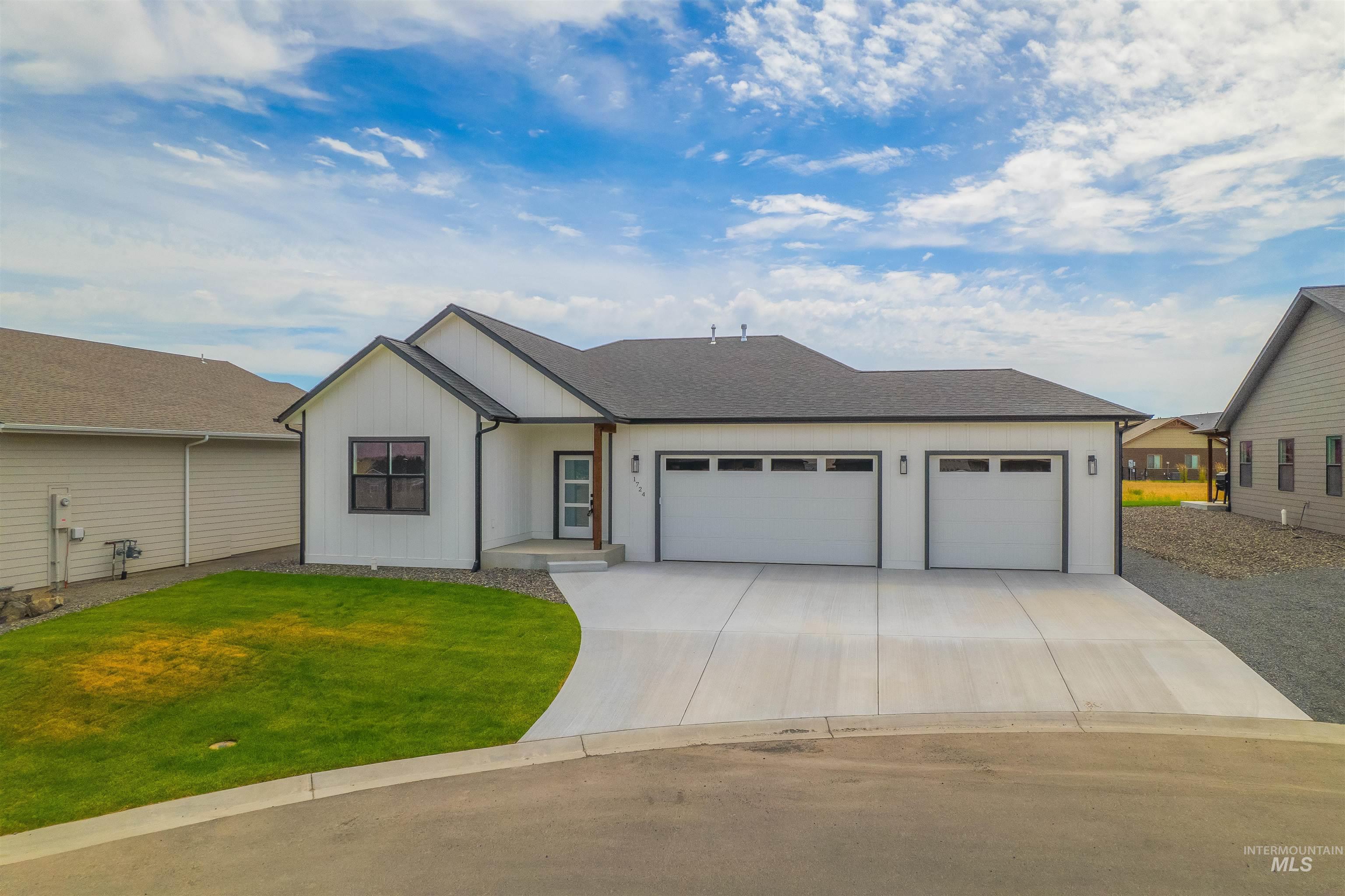 1724 Pathway Court Lewiston, ID 83501 - Photo 2 of 38 View of front of home with a garage, concrete driveway, a front yard, board and batten siding, and a shingled roof