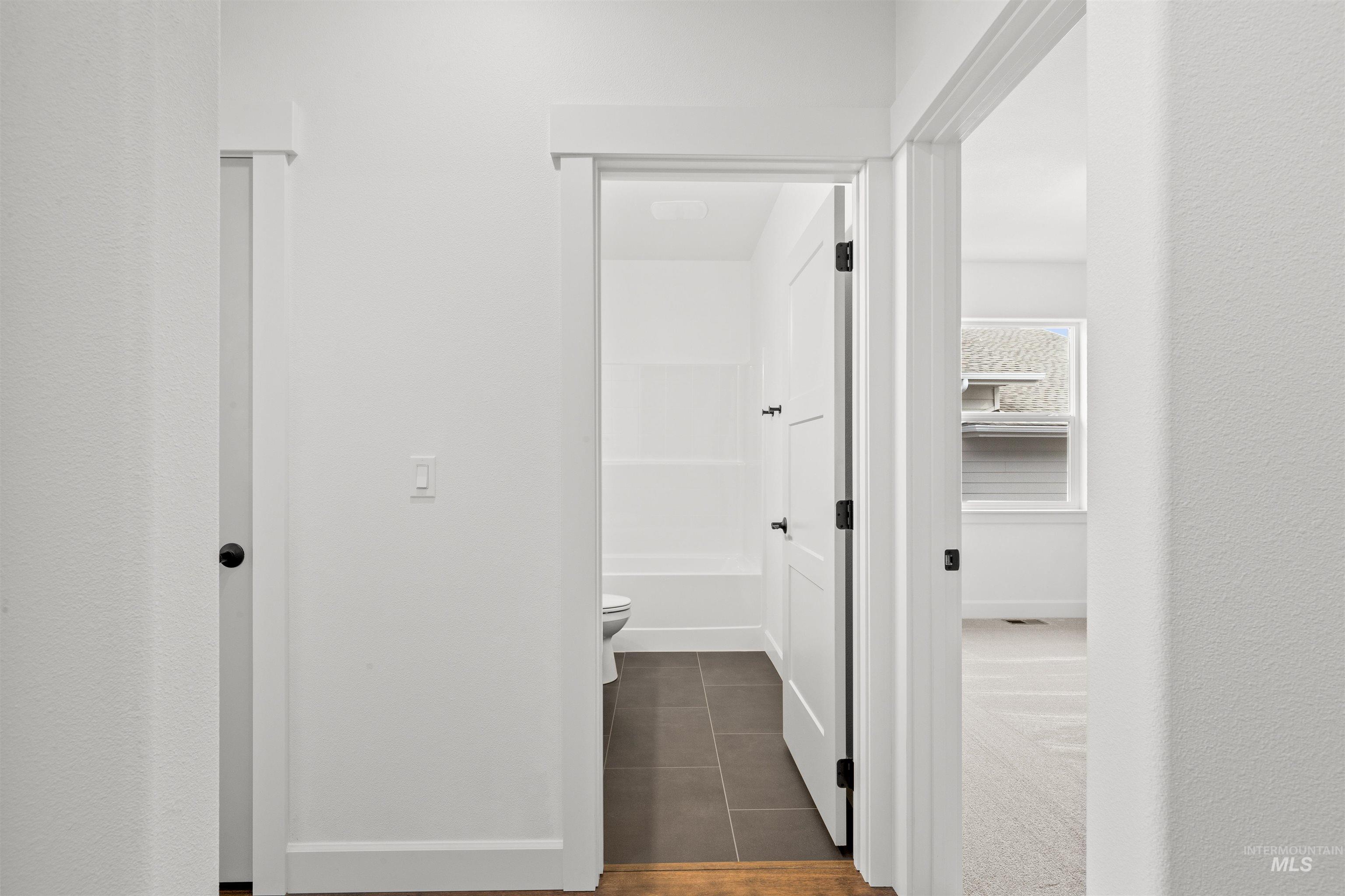 1724 Pathway Court Lewiston, ID 83501 - Photo 21 of 38 Hallway featuring baseboards and dark tile patterned floors