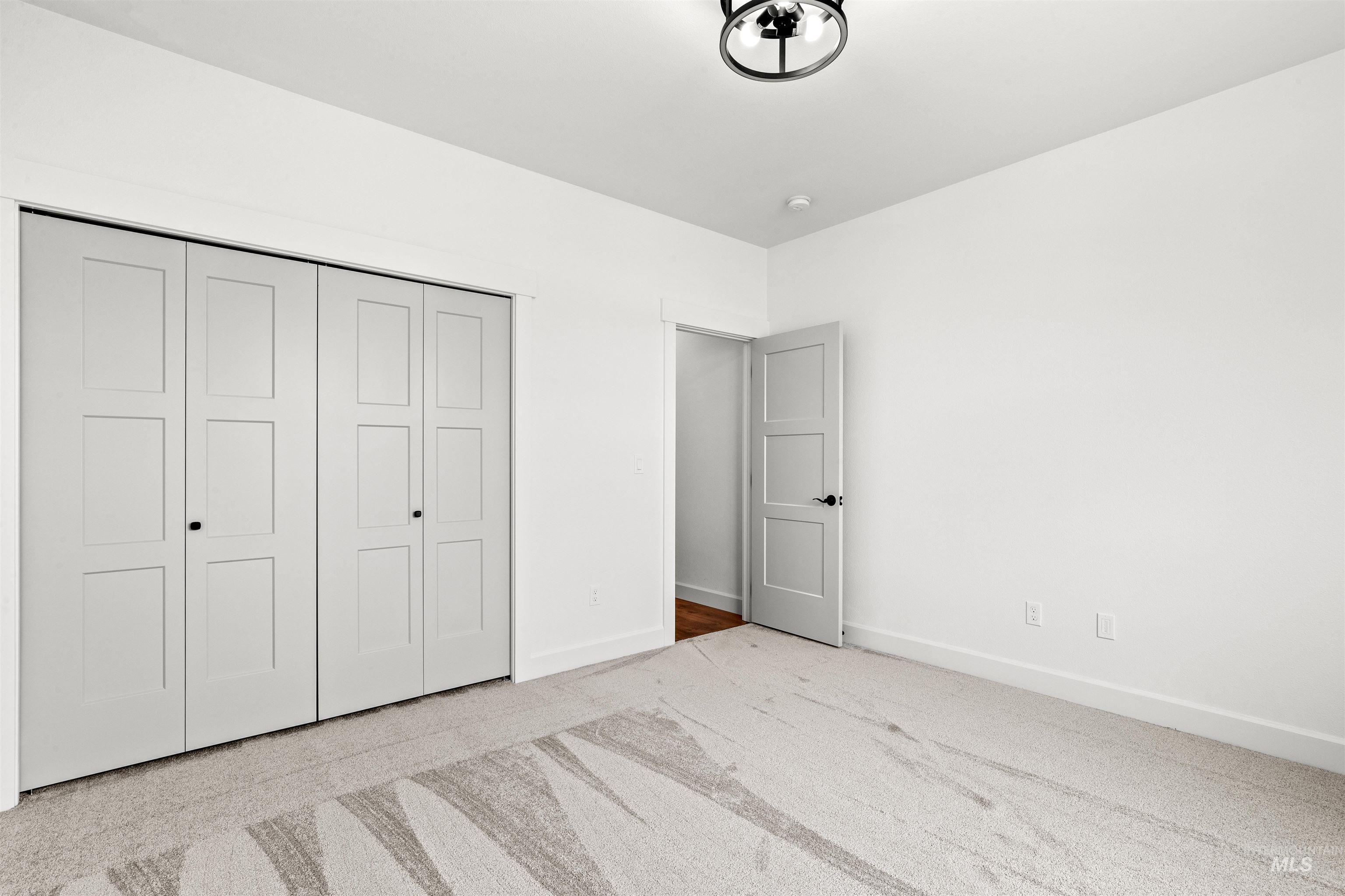 1724 Pathway Court Lewiston, ID 83501 - Photo 27 of 38 Unfurnished bedroom featuring light carpet and a closet