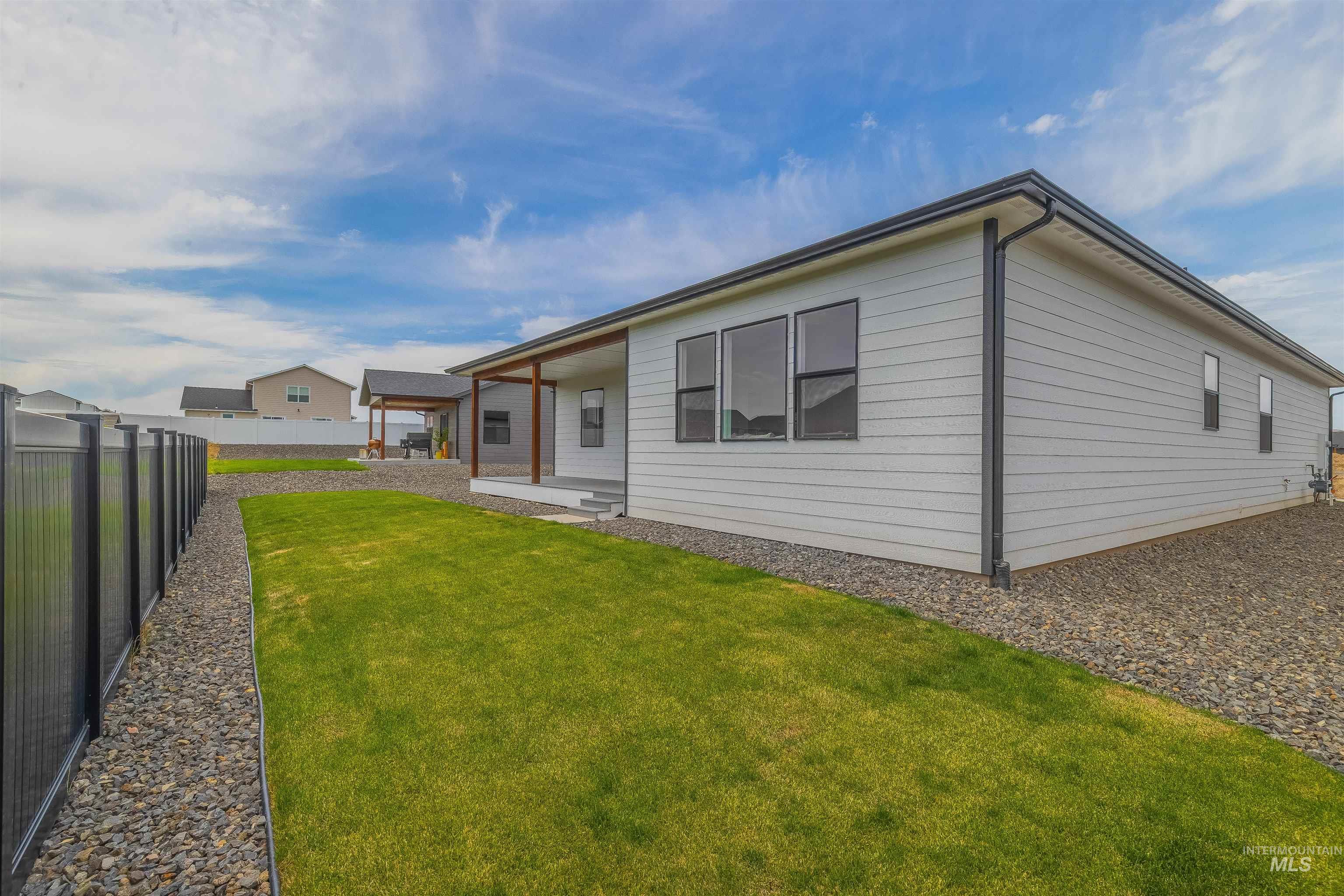 1724 Pathway Court Lewiston, ID 83501 - Photo 35 of 38 Rear view of house with a fenced backyard