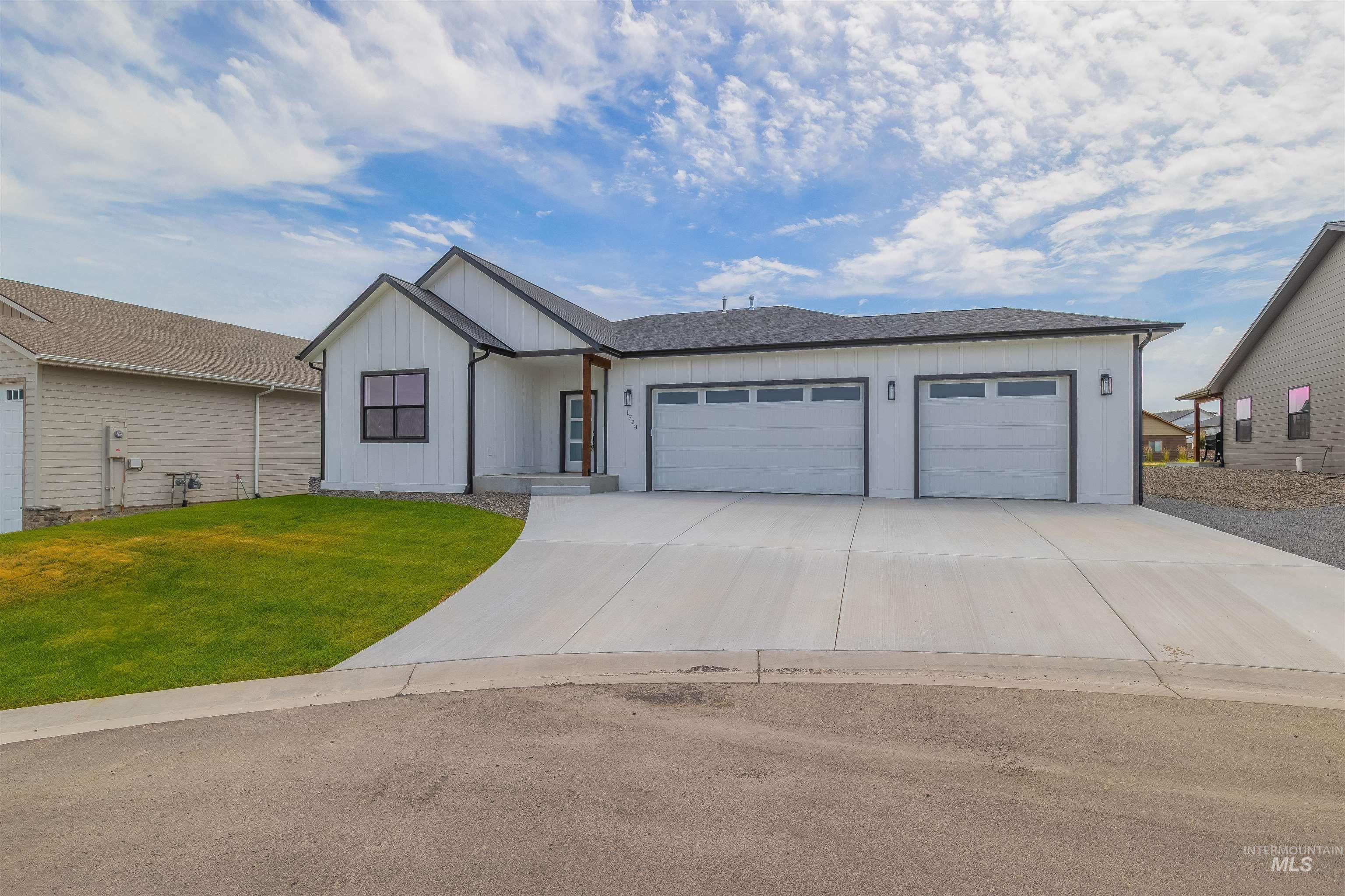 1724 Pathway Court Lewiston, ID 83501 - Photo 37 of 38 View of front of house with a garage, driveway, board and batten siding, and a front lawn